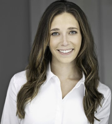 A woman (Marissa Shandel) is smiling in a white shirt for a headshot